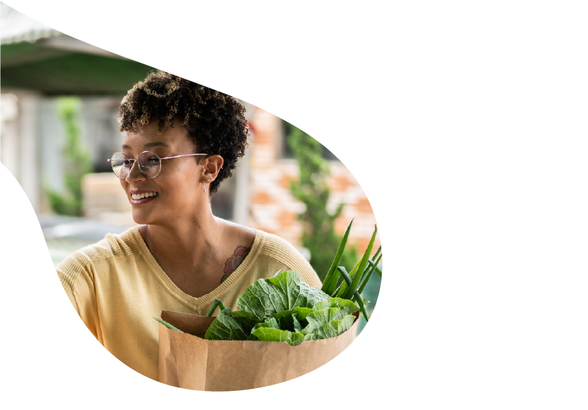 A woman with a bag full of groceries. 