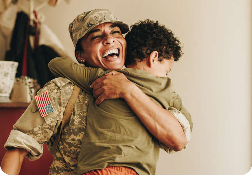 Mom coming back from deployment hugging son. Inclusion focus. 