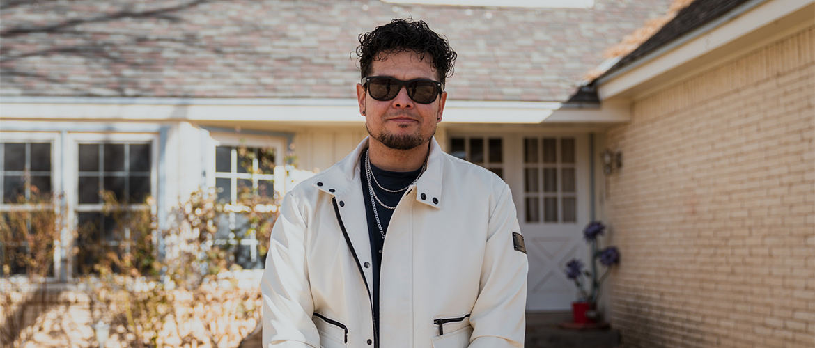 Member Juan Tejada poses outside the Albuquerque, New Mexico, home where he lives