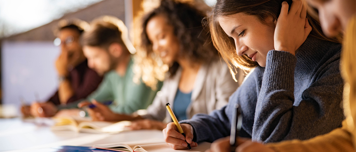 young students sit at a desk